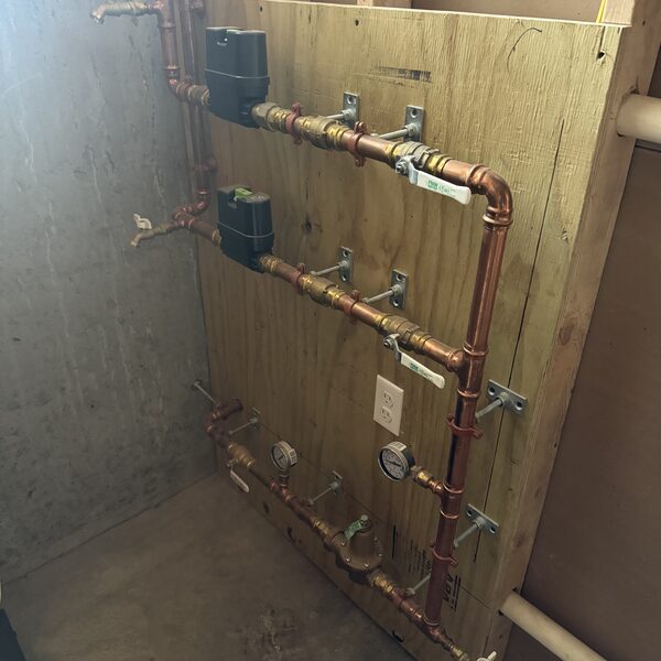 Copper heating zone manifold with shutoff valves on a backing board